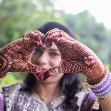 Beautiful woman dressed up as Indian tradition with henna mehndi design on her both hands to celebrate big festival of Karwa Chauth, Karwa Chauth celebrations by Indian woman for her husband