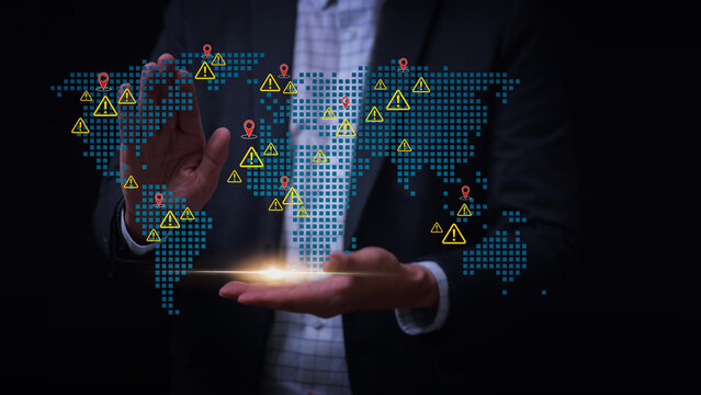 Businessman holding digital global map showing worldwide logistics network risk and managing severe supply chain disruption