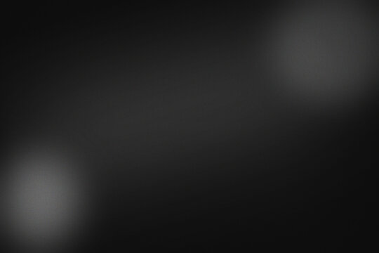 Dark gray grainy background, with two soft, out-of-focus circular light, spots in opposite, corners, creating a, moody, atmospheric texture