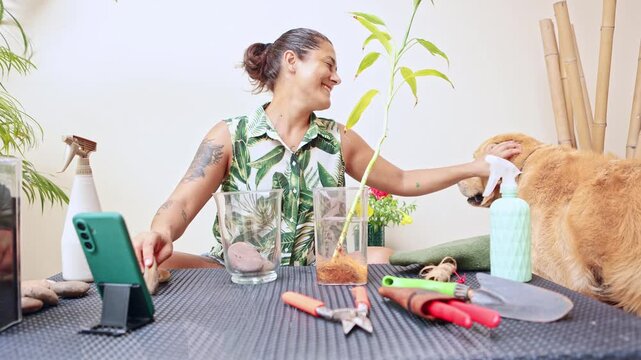 Woman petting her dog while doing a gardening tutorial