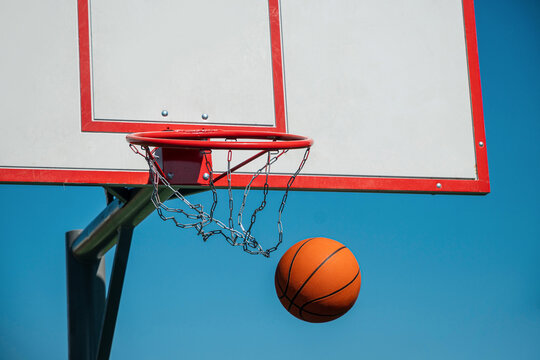 Basketball ball falling from hoop with chain net motion and miss concept