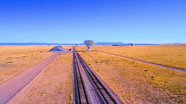 Very large array radio telescopes site new mexico with long train tracks.
