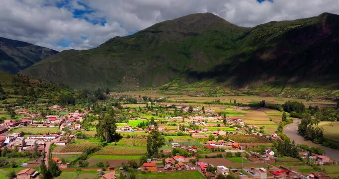 Rural village of Huayllabamba with its agricultural fields in the Sacred Valley of the Incas, Peru. Aerial drone ascending
