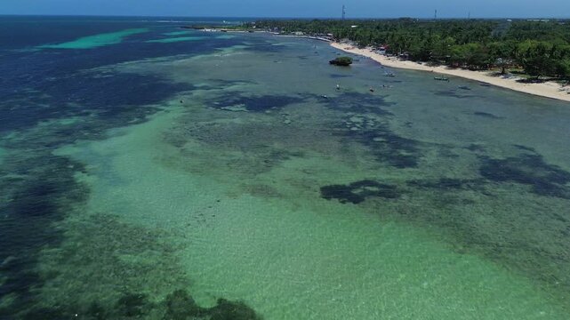Wide aerial view of Bantayan Island showing an expansive tropical coastline with beaches greenery and surrounding ocean creating a scenic island landscape in the Philippines Southeast Asia