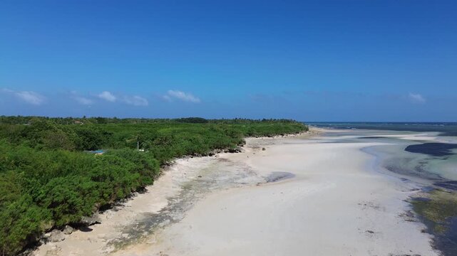Aerial view of a tropical island coastline with white sand beach clear ocean water and dense green vegetation creating a pristine and untouched landscape on Bantayan Island Philippines Southeast Asia