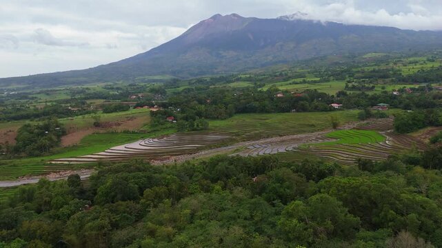 aerial view of the majestic Mount Canlaon and surrounding verdant forests and farmland in Canlaon City, Negros Oriental, Philippines. High altitude volcanic vista