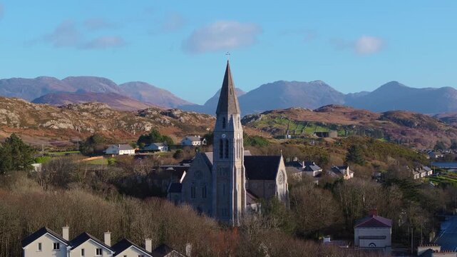 4K Aerial drone footage of St Joseph&rsquo;s Church in Clifden, Galway with Connemara Mountains Background_011