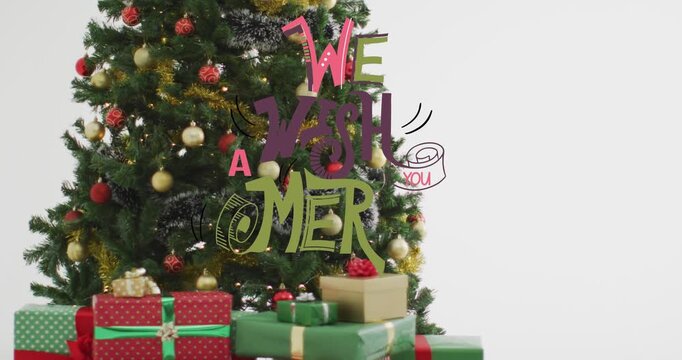 Animation of merry christmas text banner over decorated christmas tree and gifts on grey background