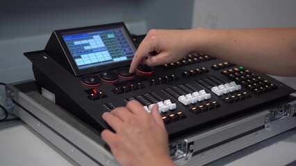 Man controlling professional lighting mixer using stylus 4k © Vital9c
