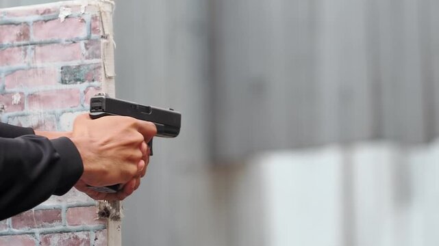 Police practices shooting with a handgun at shooting range.