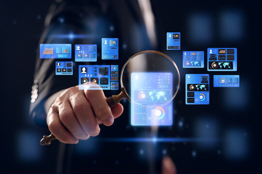 businessman holding magnifying glass looking at virtual data chart dashboard in concept of investment data analysis and DMS document audit financial Tax Fraud audit Using Magnifying Glass