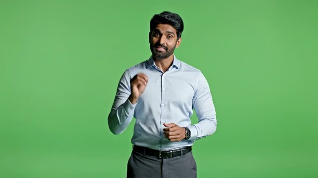 Professional man gesturing explaining or presenting on green screen backdrop ready for chroma key compositing video