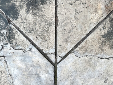 Close up of old weathered cracked concrete or cement screed with weathered grunge texture, and grouts lining pattern. Suitable for flooring and old building. Seamless background texture. 