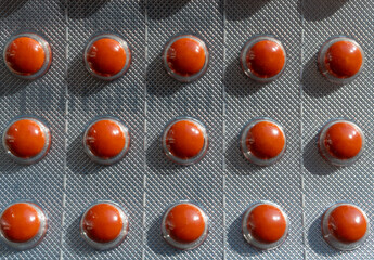 Red medicine pills closeup, macro tablets