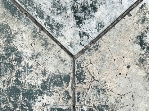 Close up of old weathered cracked concrete or cement screed with weathered grunge texture, and grouts lining pattern. Suitable for flooring and old building. Seamless background texture. 