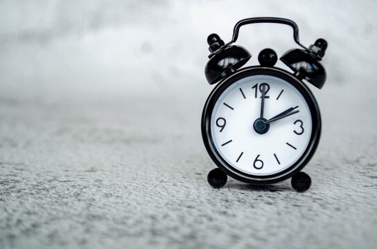Minimal alarm clock thumbnail depicting a two o clock afternoon time reference with a calm monochrome tabletop presentation.
