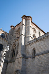 Obraz premium Stone cathedral structure under clear blue sky.. Cathedral of Ávila, Spain