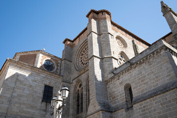 Obraz premium Historic cathedral structure against a clear blue sky.. Cathedral of Ávila, Spain