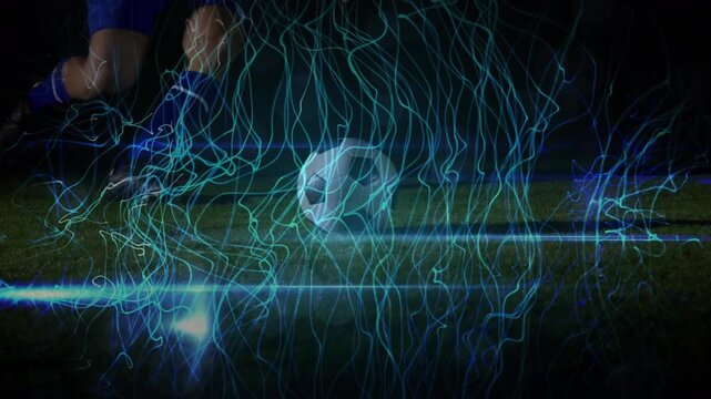 Soccer player performing a sliding tackle on playing field at night in 4k