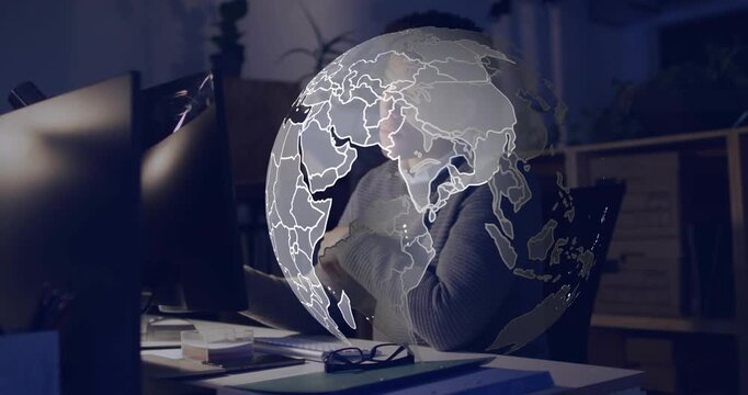 Tech man rubbing reaching for mug as globe emerging from right covering him, refocusing on monitor