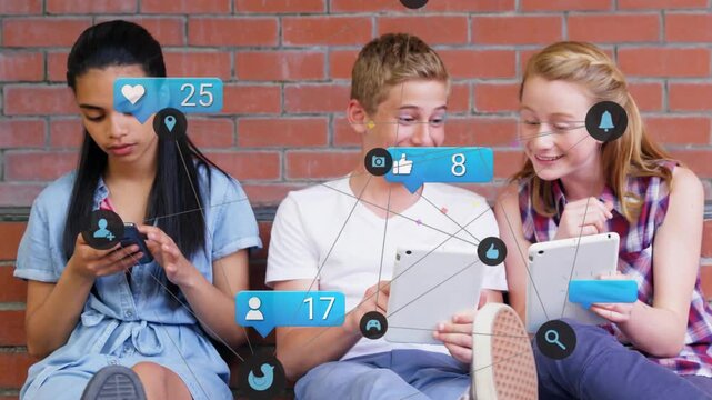 Icons appearing, three teens tapping phone and tablets on bench, brick wall, sharing reactions