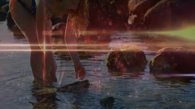 Vertical video: Woman seeing fish scooping rock lifting arms sending ripples tech overlaying hands