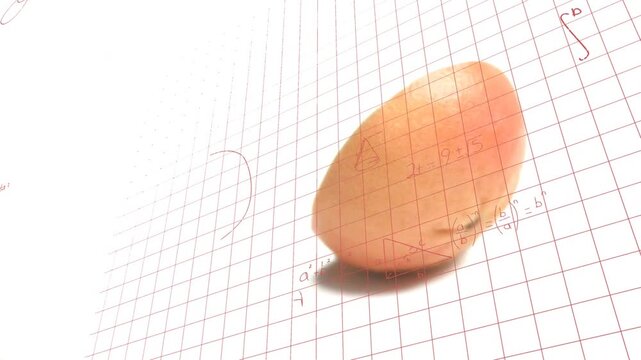Pink grapefruit wedge rotating and rolling on red grid, camera shifting illustrating math notes