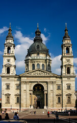 Exterior view of St. Stephen's Basilica in Budapest, Hungary, with people walking in the square.