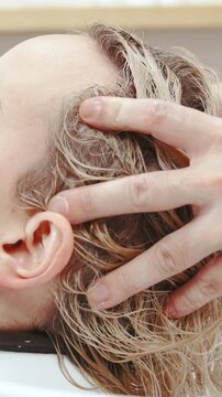 Hairdresser gentle massage of woman head