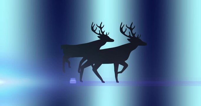 Snow falling over silhouette of reindeer walking against orange background