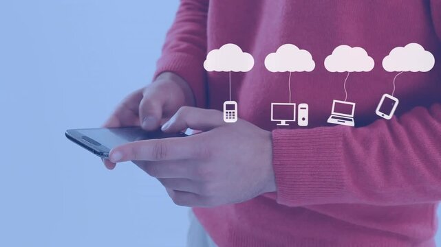 Animation of icons hanging on clouds over midsection of businessman typing on smartphone
