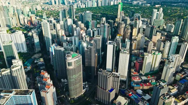 Cinematic glide over Ayala Avenue financial district with dense skyscrapers