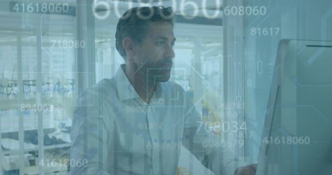 Animation of financial data processing over caucasian businessman with computer in office