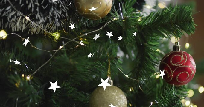 Animation of snow falling over christmas tree with baubles