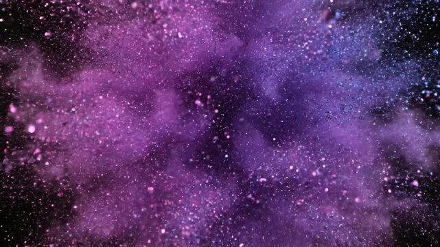 Exploding iridescent glitter ball reveals a vibrant pink and blue cloud against a dark background.