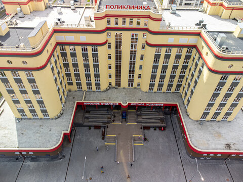 High-angle drone shot (top-down / bird's-eye view) of the main building of City Polyclinic No. 5 (GAUZ TO "Gorodskaya poliklinika No. 5") in Tyumen, Russia, captured on September 12, 2022, using a DJI