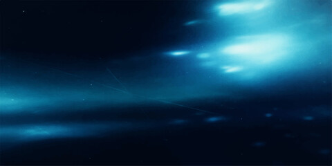 Abstract blue space background featuring a bright digital star glow and light beam rays across a dark night sky design © Abdul