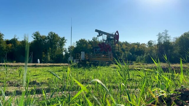 Extraction of petroleum. Oil Pump Jack on blue. Oil Field. Petrolium crude Industrial. Crude pump jack working.. Extraction of petroleum in oilfield. Crude petroleum industry
