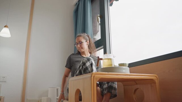 Energetic hotel room morning with movement, guest reaches for cup and almost spills, adjusts curtain and glances out window, pajama outfit and compact tray, bright interior, quick casual rhythm