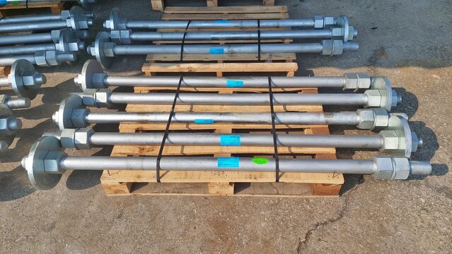 Anchor Bolts With Nuts Stored On Wooden Pallets