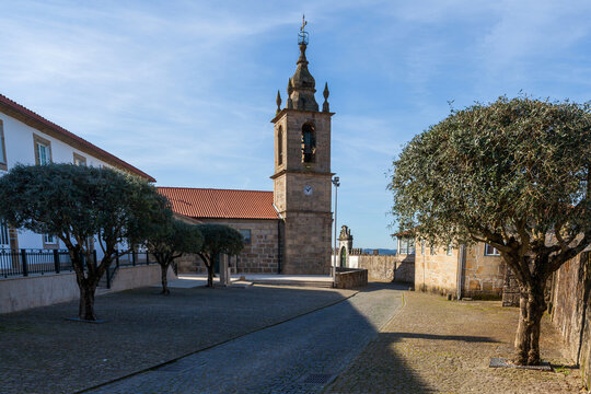 A traditional portuguese stone church with a tall bell tower fea