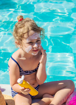 The child has sunscreen on his face. Selective focus.