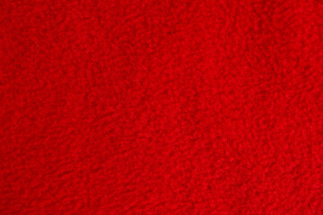 Red fleece fabric texture background, soft warm textile material close up © Iryna Miadzvedzeva