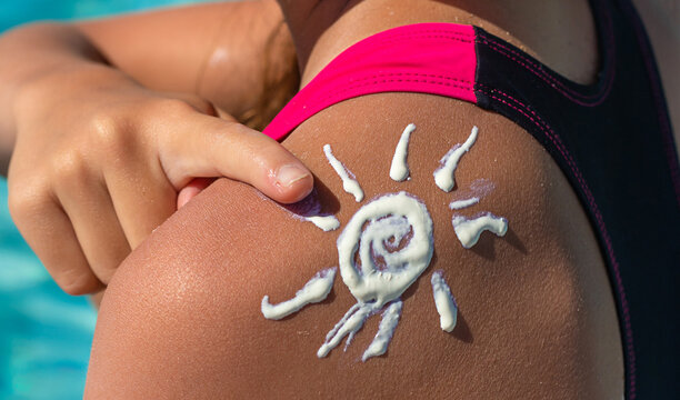 The child has sunscreen on his back. Selective focus.