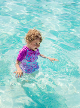 Child swimming in the pool. Selective focus.