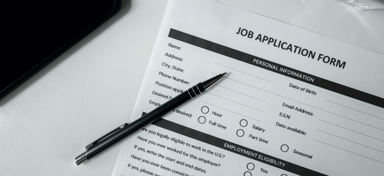 Job application form with pen on the table. Employment, hiring and recruitment agency concept