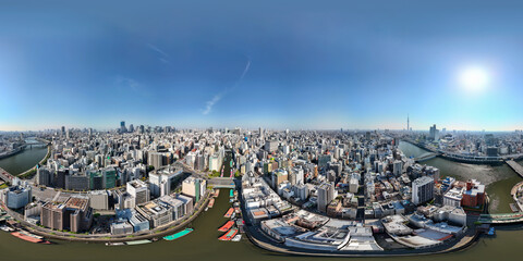 Full 360 degrees panorama of Tokyo skyline captured by drone over Sumida River in Yanagibashi, showcasing urban cityscape and clear skies © jovannig