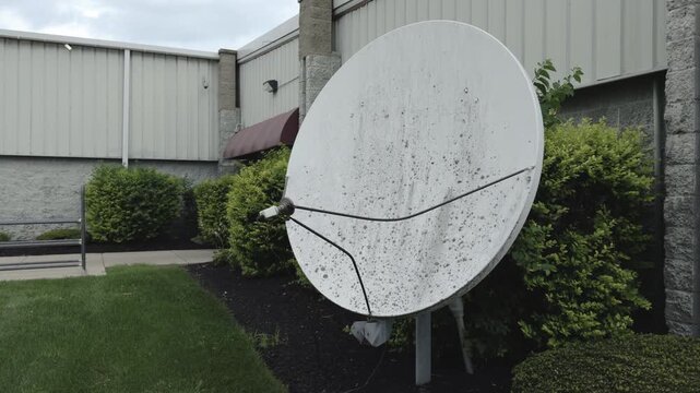 Satellite dish in front of commercial building 4k