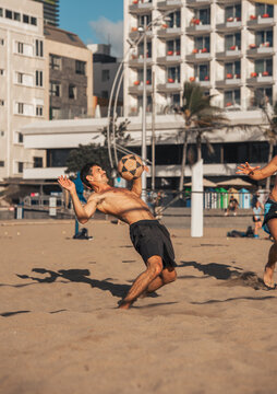 young man playing footvolley in Las Canteras beach. Las Palmas de Gran Canaria. Canary Islands. Spain.