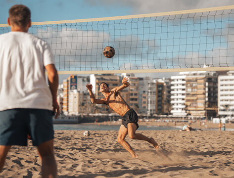young man playing footvolley in Las Canteras beach. Las Palmas de Gran Canaria. Canary Islands. Spain.